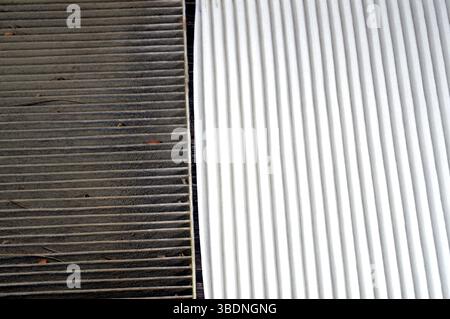 dirty old used car AC air conditioning filter full of dust removed from the vehicle to be replaced with a new one and a new cabin air carbon filter, r Stock Photo