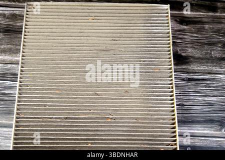 old dirty used car AC air conditioning filter full of dust removed from the vehicle to be replaced with a new one, cabin air carbon filter, rectangula Stock Photo