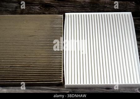 dirty old used car AC air conditioning filter full of dust removed from the vehicle to be replaced with a new one and a new cabin air carbon filter, r Stock Photo