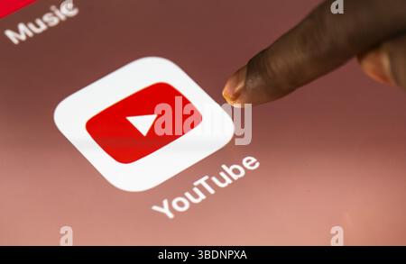 In this photo Illustration a person taps Googles Youtube application on a tablet device on 24 May 2025 in New Delhi, India, Asia Stock Photo