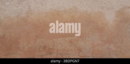 Weathered concrete wall showing signs of age and texture creating an abstract background Stock Photo