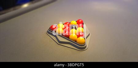 Billiard balls arranged in a triangle on a pool table Stock Photo
