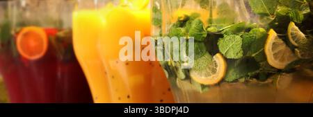 Refreshing drinks. Mojitos and lemonades in plastic containers at the food court. Assortment of summer drinks. Drinks on tap. Bar with drinks Stock Photo
