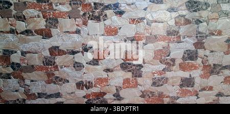 Multicolored stone cladding tiles forming a textured wall, perfect for rustic interior or exterior design projects Stock Photo