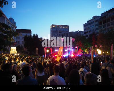 Athens, Greece - May 4 2025: Crowd gathered with colorful lights and decorations in an Athens square during Athens City Festival 2025 Stock Photo