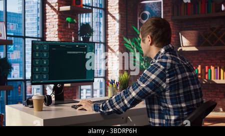 Man having fun interacting with AI LLM chatbot PC GPT software on PC in modern home office. User using large language model application communicating through artificial intelligence, camera A Stock Photo