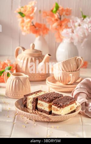 Delicious sponge cake made of cream, chocolate and biscuits. Sponge cake with foam and chocolate. Stock Photo