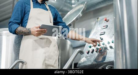 Male worker on beer factory, management and mobile app Stock Photo
