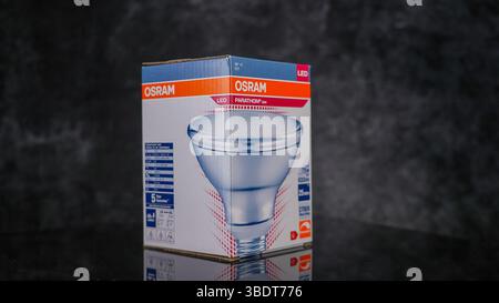 Osram LED PARATHOM classic A60 75W light bulb in its cardboard box on a reflective surface - FRANKFURT, GERMANY - APRIL 9, 2025 Stock Photo