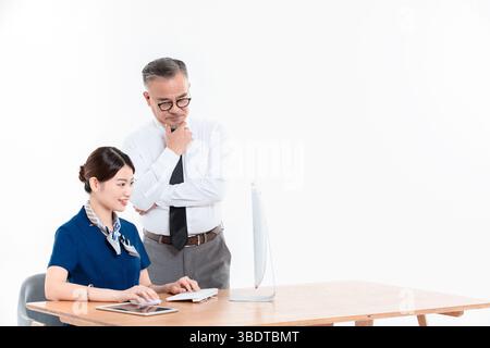 A business elderly man and a young woman standing (sitting) at the office desk Stock Photo