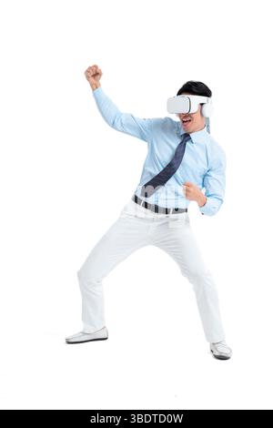 A suited man wearing a VR headset waves both hands vigorously Stock Photo