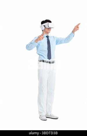 A suited man wearing a VR headset waves both hands vigorously Stock Photo