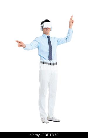 A suited man wearing a VR headset waves both hands vigorously Stock Photo