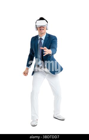 A suited businessman interacts with virtual objects through frenzied gestures, wearing VR/AR headset Stock Photo