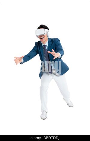 A suited businessman interacts with virtual objects through frenzied gestures, wearing VR/AR headset Stock Photo