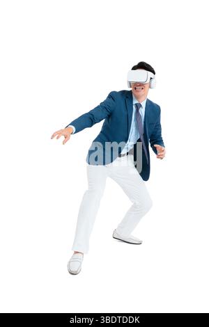 A suited businessman interacts with virtual objects through frenzied gestures, wearing VR/AR headset Stock Photo