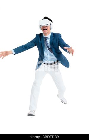 A suited businessman interacts with virtual objects through frenzied gestures, wearing VR/AR headset Stock Photo