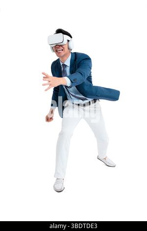 A suited businessman interacts with virtual objects through frenzied gestures, wearing VR/AR headset Stock Photo