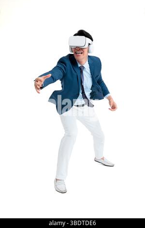 A suited businessman interacts with virtual objects through frenzied gestures, wearing VR/AR headset Stock Photo