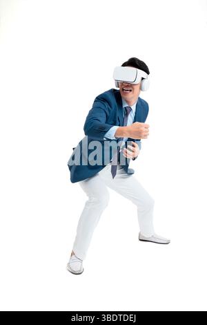 A suited businessman interacts with virtual objects through frenzied gestures, wearing VR/AR headset Stock Photo