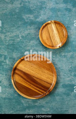 round wood plate on blue background texture. food photography, top view Stock Photo
