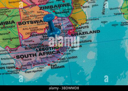 A blue pin marks the location of Lesotho on a colorful map featuring surrounding countries, including South Africa and Swaziland, showcasing regional Stock Photo