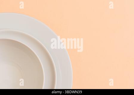 Clean aesthetic: white plates in an artistic arrangement.Concepts. Stock Photo
