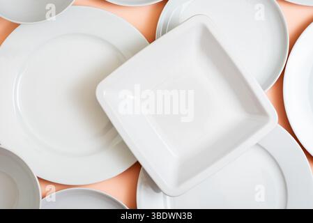 Culinary contrast: white square plate on round white plates background.Concepts. Stock Photo
