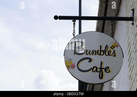 Outdoor Sign of Bumbles Cafe Featuring Cartoon Bees Signage. Chichester, UK Stock Photo