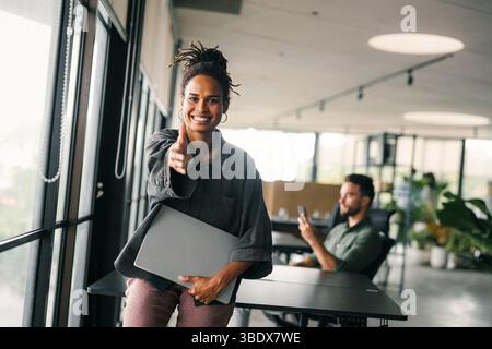 Smiling black successful business woman, freelancer, coworker female leader using digital device Stock Photo