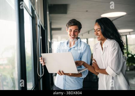 Multicultural professional businesspeople working together on research plan in boardroom. Stock Photo