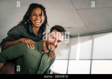 Cheerful diverse coworkers having fun during work break using technology enjoying working together Stock Photo