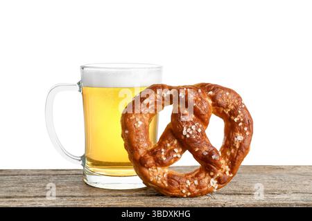 Tasty pretzel and glass of beer on wooden table against white background Stock Photo