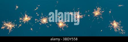Burning sparklers collection on blue background, abstract banner Stock Photo