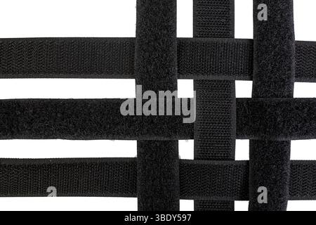 Velcro sticky tape strips pairs overlapping in a grid pattern, isolated on white background, flat lay Stock Photo