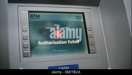 Unrecognizable Person Entering PIN Code on ATM Keypad to Withdraw Money. Error Message on Cash Machine Display About Transaction Cancellation Due to Failed Authorization. Banking Equipment. Close Up. Stock Photo