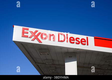 Missoula, MT, USA - May 7, 2025; Exxon Diesel sign on canopy under blue sky Stock Photo