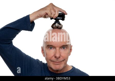 Man Shaving His Head With Electric Razor on White Background Stock Photo