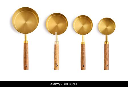 Golden measuring spoons with wooden handles isolated on white background Stock Photo