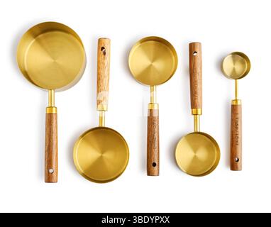 Golden measuring spoons with wooden handles isolated on white background Stock Photo