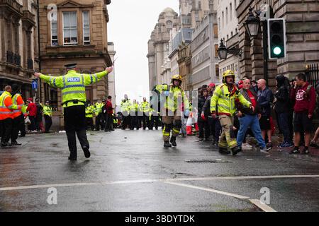 Police and emergency personnel dealing with a road traffic accident on Water Street near the Liver Building in Liverpool after a car collided with pedestrians during the Premier League winners parade. A man has been detained. Picture date: Monday May 26, 2025. Stock Photo