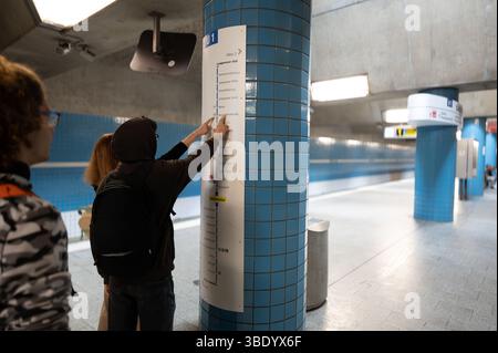 Nuremberg, Germany, August 1, 2023. A young Caucasian man and a middle-aged woman check the route on the subway map counting the stops to their destin Stock Photo
