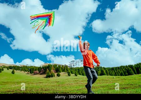 Happy boy with kite on mountains background Stock Photo