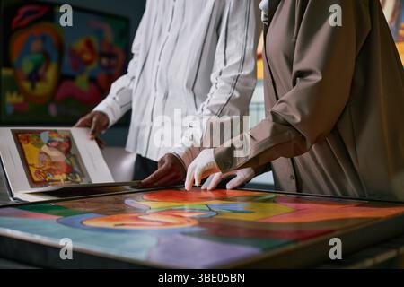 Observing Artworks at Modern Art Gallery Exhibit Stock Photo