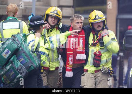Police and emergency personnel dealing with a road traffic collision on Water Street near the Liver Building in Liverpool after a car collided with pedestrians during the Premier League winners parade. A man has been detained. Picture date: Monday May 26, 2025. Stock Photo
