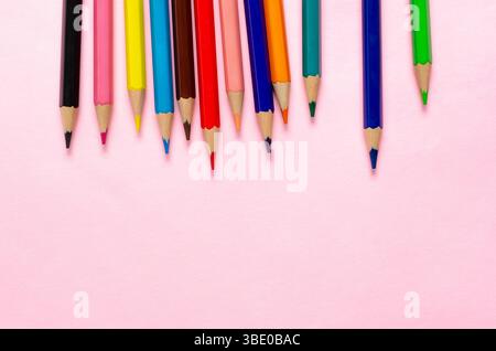 Collection of colorful sharpened pencils on a pink background. Stock Photo
