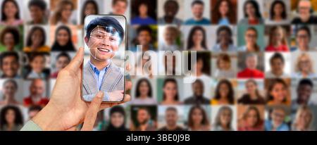 A person holds a smartphone displaying a facial recognition scan Stock Photo