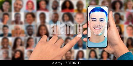 A person holds a smartphone displaying a facial recognition feature Stock Photo