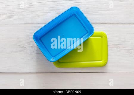 Empty plastic lunch boxes on white wood, top view Stock Photo