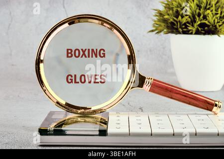 The words BOXING GLOVES Concept of health, sports through a magnifying glass, close-up, front view. Stock Photo